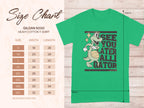 Garment Graphics casual green T-shirt showcases a cartoon alligator with a basketball and the text SEE YOU LATER ALLIGATOR. A Gildan 5000 Heavy Cotton size chart is included, detailing sizes S to 5XL with width and length in inches.