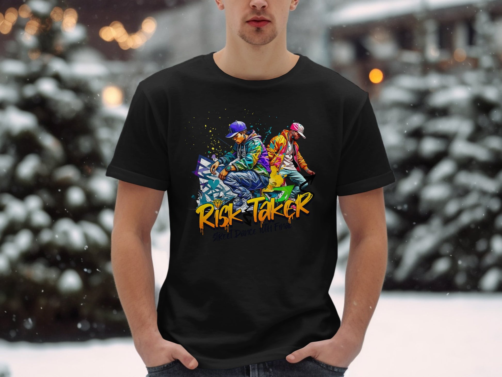In a snowy setting, someone wears Garment Graphics black T-shirt featuring two skateboarders and the words Risk Taker, showcasing street dance culture against blurry snow-covered trees.