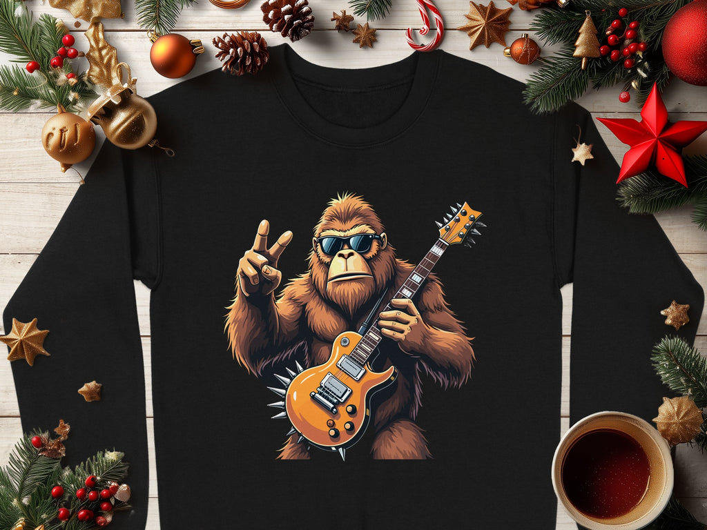 The Garment Graphics black shirt showcases Bigfoot with sunglasses, an electric guitar, and a peace sign among Christmas decorations like fir branches, ornaments, candy canes, and coffee. Its ideal for music lovers who cherish the holiday spirit.