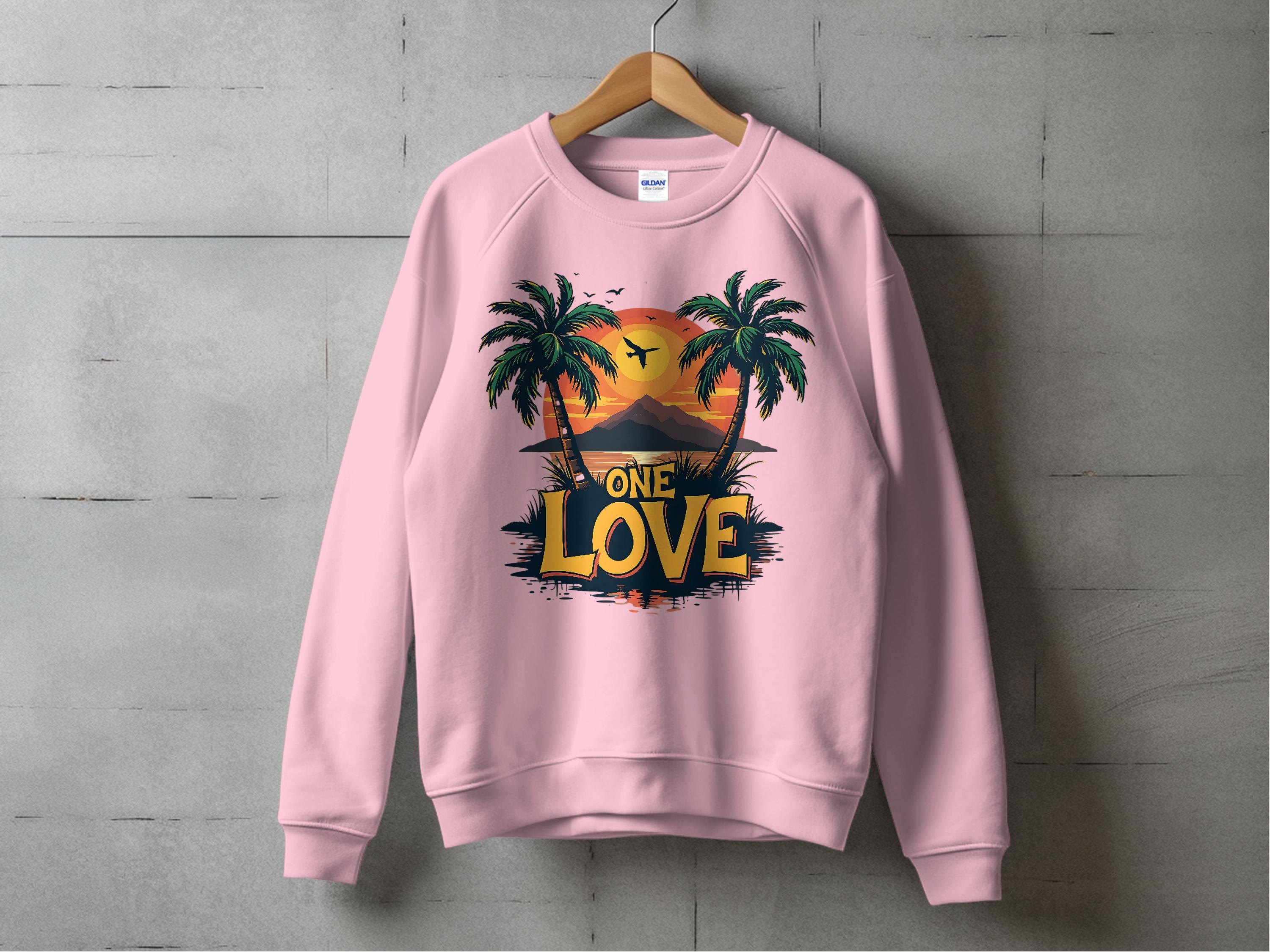 Garment Graphics One Love Sweatshirts collection features a unisex pink sweatshirt on a wooden hanger. It displays a sunset graphic with palm trees and birds, and ONE LOVE in bold yellow and black, set against a textured gray wall backdrop.