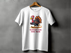 Garment Graphics presents a funny graphic T-shirt on a wooden hanger against a gray background, showcasing a cartoon turkey running with TURKEY ON THE RUN in bold red letters. Available in family sizing for all to enjoy.