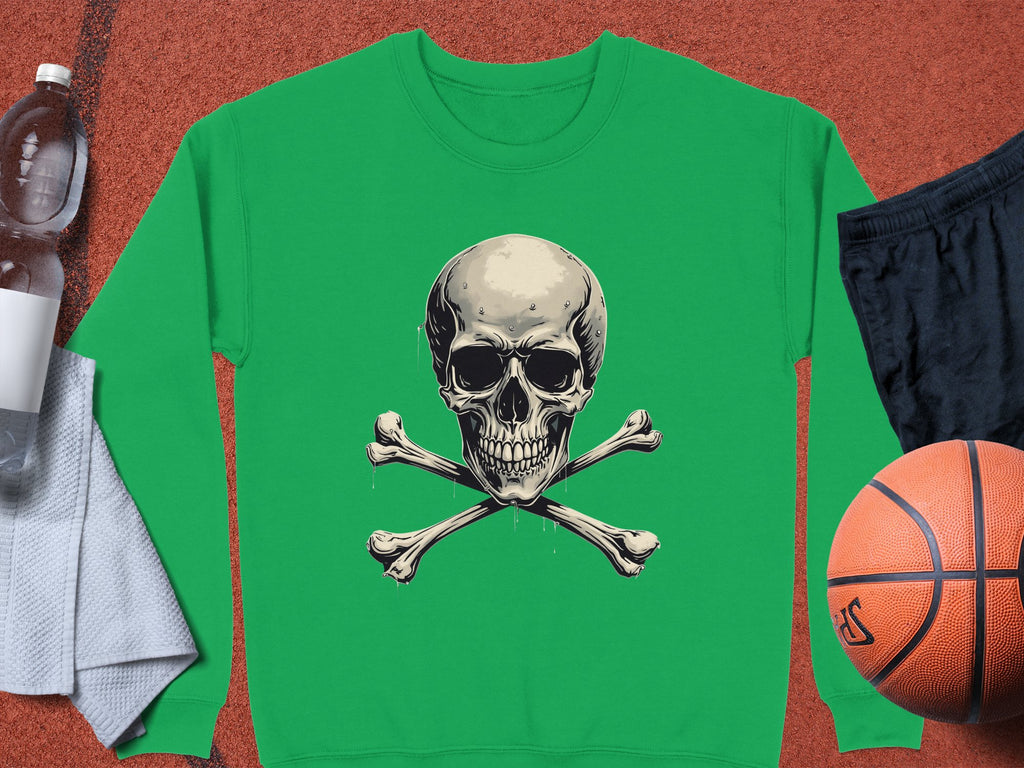 A bold and edgy green Garment Graphics sweatshirt featuring a skull and crossbones design is displayed on a surface, alongside a towel, water bottle, black shorts, and a basketball.