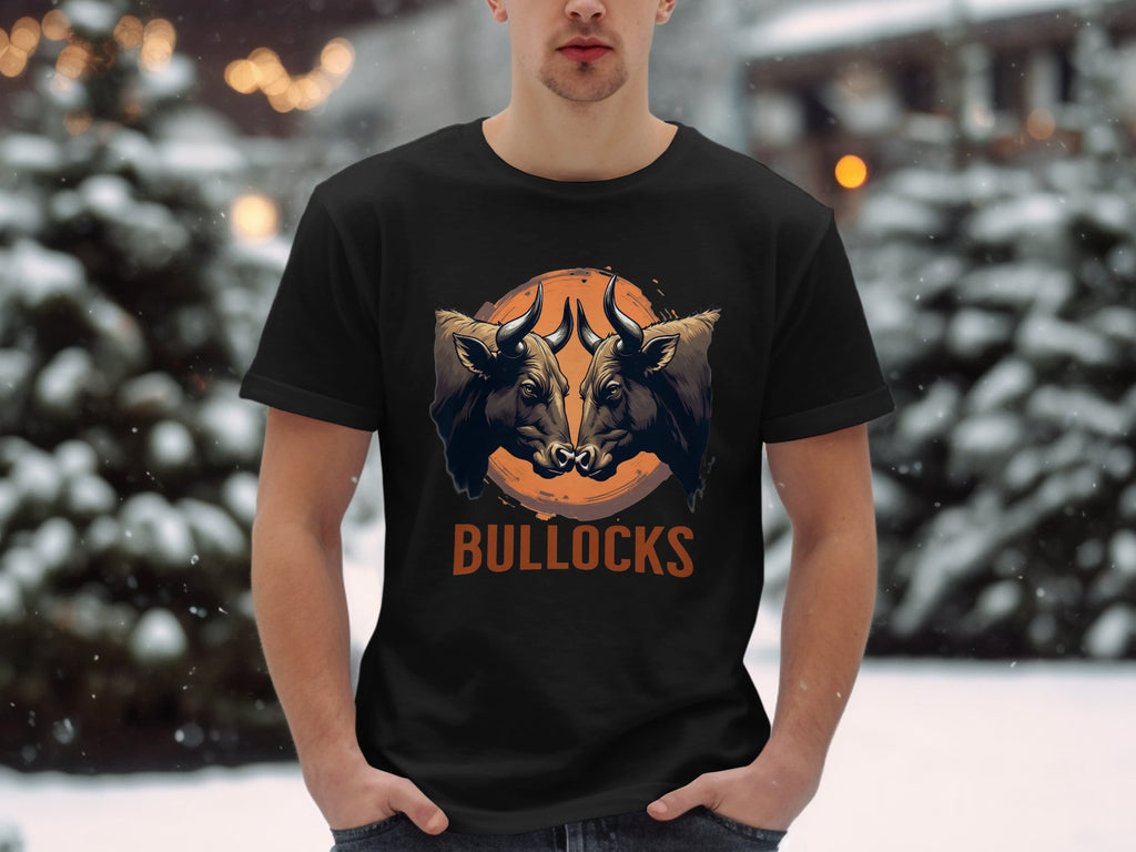 A person wears a Garment Graphics black classic fit T-shirt with two bulls, a basketball background, and BULLOCKS in orange. The Bullocks Pintable T-Shirt offers family sizing, perfect for snowy forest outings.