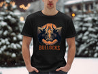 A person wears a Garment Graphics black classic fit T-shirt with two bulls, a basketball background, and BULLOCKS in orange. The Bullocks Pintable T-Shirt offers family sizing, perfect for snowy forest outings.