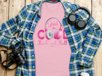 A pink Garment Graphics Rock and Roll T-shirt with Just be Cool, Rock and Roll text and a headphones design lies on a blue and green plaid shirt. Nearby are a black camera, black headphones, and a white paper cup on wood—ideal for music fans.
