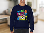 Someone wearing a Garment Graphics dark blue unisex sweatshirt with vibrant designs and the text LOUD & PROUD, featuring a megaphone, symbols, and phrases like Hey Yo Lets Go and Lets Make Some Noise! stands out uniquely against a blurred indoor background.