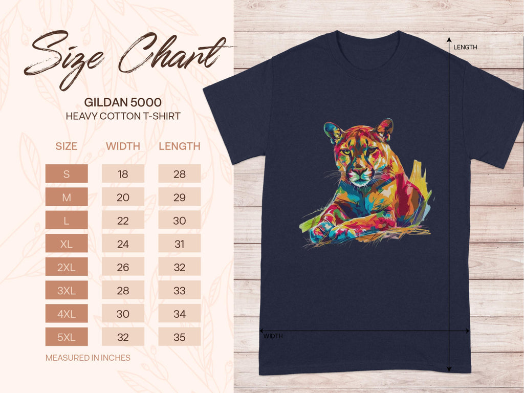 Next to a navy T-shirt featuring vibrant artwork of a colorful roaring cougar, Garment Graphics displays a size chart for the Gildan 5000 Heavy Cotton T-shirt. Sizes range from S to 5XL with corresponding width and length in inches.