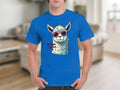 Someone is wearing a blue Llama T-shirt from Garment Graphics, featuring a llama in red sunglasses and No Prob-Llama text. Set against a softly blurred indoor background with neutral tones, these fun tees come in family sizes, adding humor to any wardrobe.