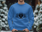 A person wears a blue sweatshirt by Garment Graphics, featuring the Scania Power 8 logo with stylized lions. Snow-covered trees and a gentle bokeh effect in the background capture the serene essence of winter.