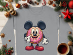 Garment Graphics presents a fun sweatshirt showcasing a cartoon donut with mouse ears, arms, and legs. This playful piece is surrounded by holiday elements including pine branches, ornaments, pine cones, and a coffee cup on wood.