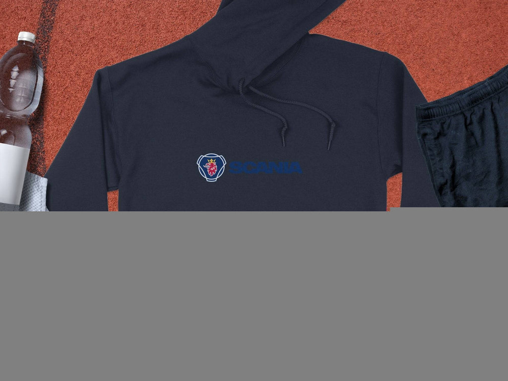 A black Garment Graphics hoodie featuring Scania’s iconic logo and blue text lies on a textured surface next to a clear water bottle, white towel, black athletic shorts, and a basketball, combining sporty style with uniqueness.