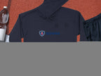 A black Garment Graphics hoodie featuring Scania’s iconic logo and blue text lies on a textured surface next to a clear water bottle, white towel, black athletic shorts, and a basketball, combining sporty style with uniqueness.