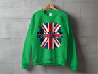 A comfortable green sweatshirt by Garment Graphics hangs on the wall, featuring a bold design with a distressed Union Jack and the striking text DONT BLAME ME, I DIDNT VOTE FOR HIM printed over the flag.