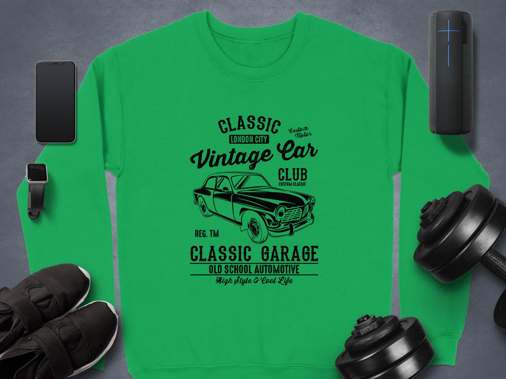 Garment Graphics offers a green sweatshirt with a vintage car design and Classic Vintage Car Club, London City, Classic Garage, Old School Automotive text. Suggested accessories: smartphone, earphones, smartwatch, sneakers, dumbbells, portable speaker.