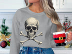 In a white kitchen adorned with Christmas ornaments and greenery, a person wearing Garment Graphics edgy gray skull-and-crossbones sweater cradles a Santa torso-shaped mug, forming a festive yet stylishly bold scene.