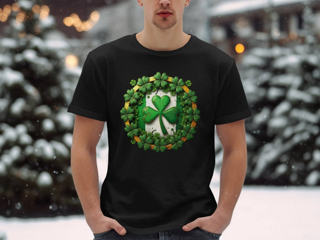 Against a snowy backdrop with blurred lights and snow-covered trees, someone stands wearing a black T-shirt by Garment Graphics. Its decorated with a large shamrock clover encircled by smaller clovers, perfect for celebrating St Patricks Day.