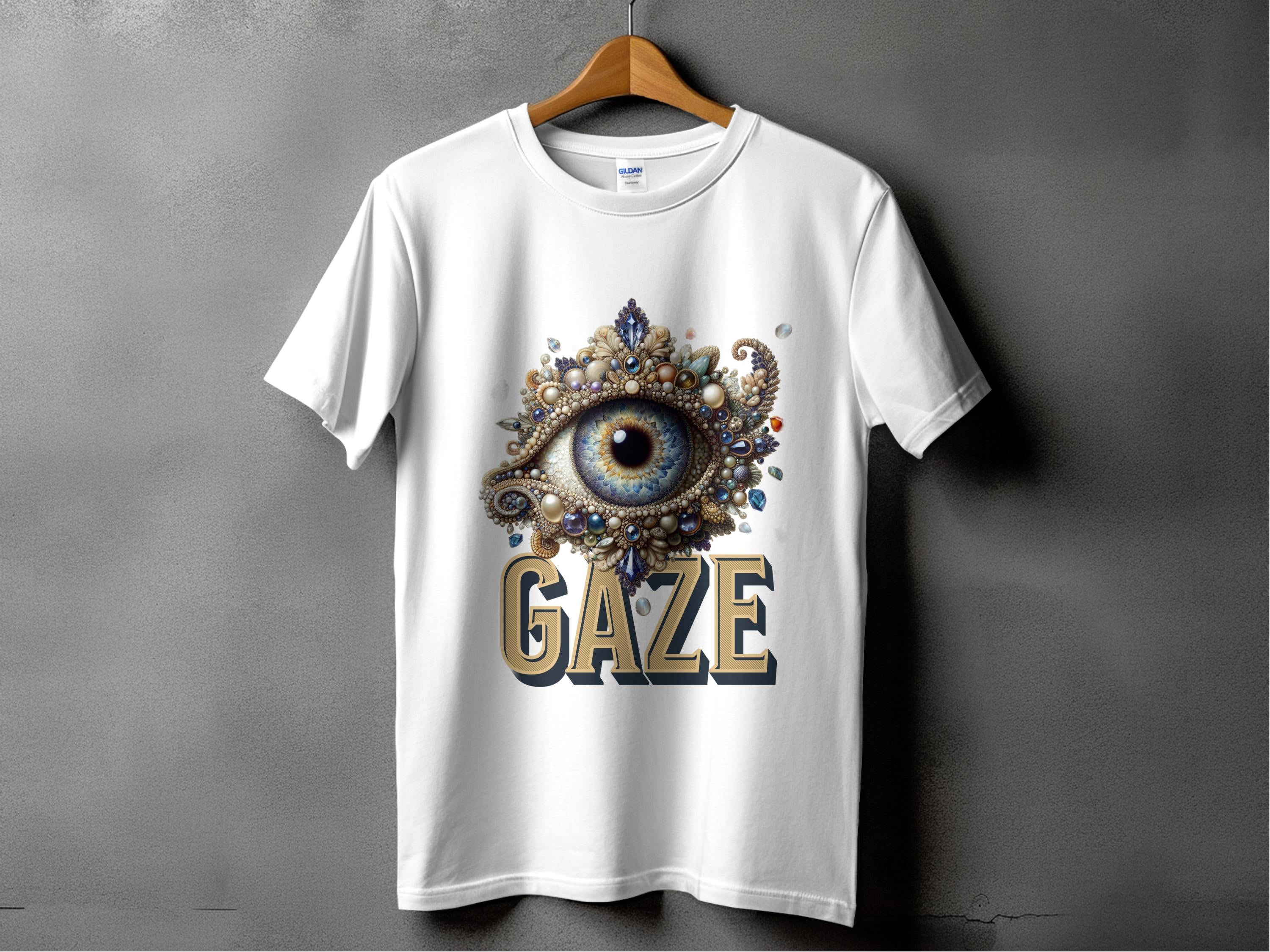 Garment Graphics classic fit graphic T-shirt hangs on a gray wall, featuring an ornate, jeweled blue eye design with GAZE printed boldly underneath.