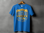 A blue t-shirt by Garment Graphics features a funny yellow and white quote: If hes got golf clubs in his truck or a camper in his driveway, dont hire him. Hanging on a hanger, its the ideal gift for those who appreciate humor and wit.