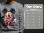 Someone is wearing a quirky Garment Graphics sweatshirt featuring a cute cartoon donut with mouse ears. Next to them is a size chart for the Gildan 18000 sweatshirt, highlighting measurements from S to 5XL.