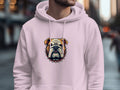 Someone is wearing a Garment Graphics hoodie showcasing a striking bulldog face with its iconic spiked collar, standing on a blurred city street.