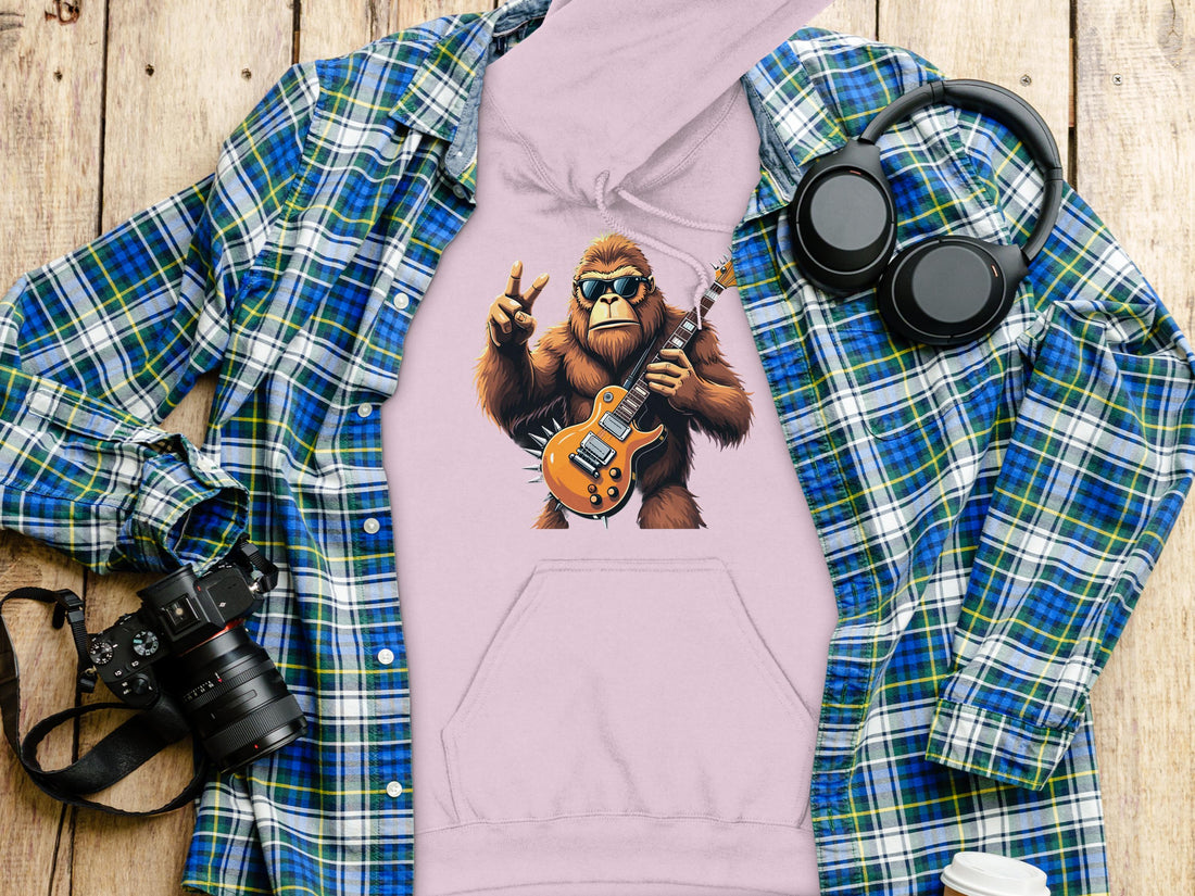 Someone is wearing a black hoodie from Garment Graphics featuring a Guitar Playing Gorilla with sunglasses and a peace sign, ideal for animal lovers and music enthusiasts.