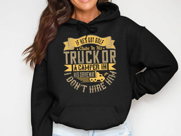 Dressed in a Garment Graphics black golf hoodie, featuring the gold text: If hes got golf clubs in his truck or a camper in his driveway, I dont hire him. Its the perfect gift, and theyre smiling with relaxed arms.